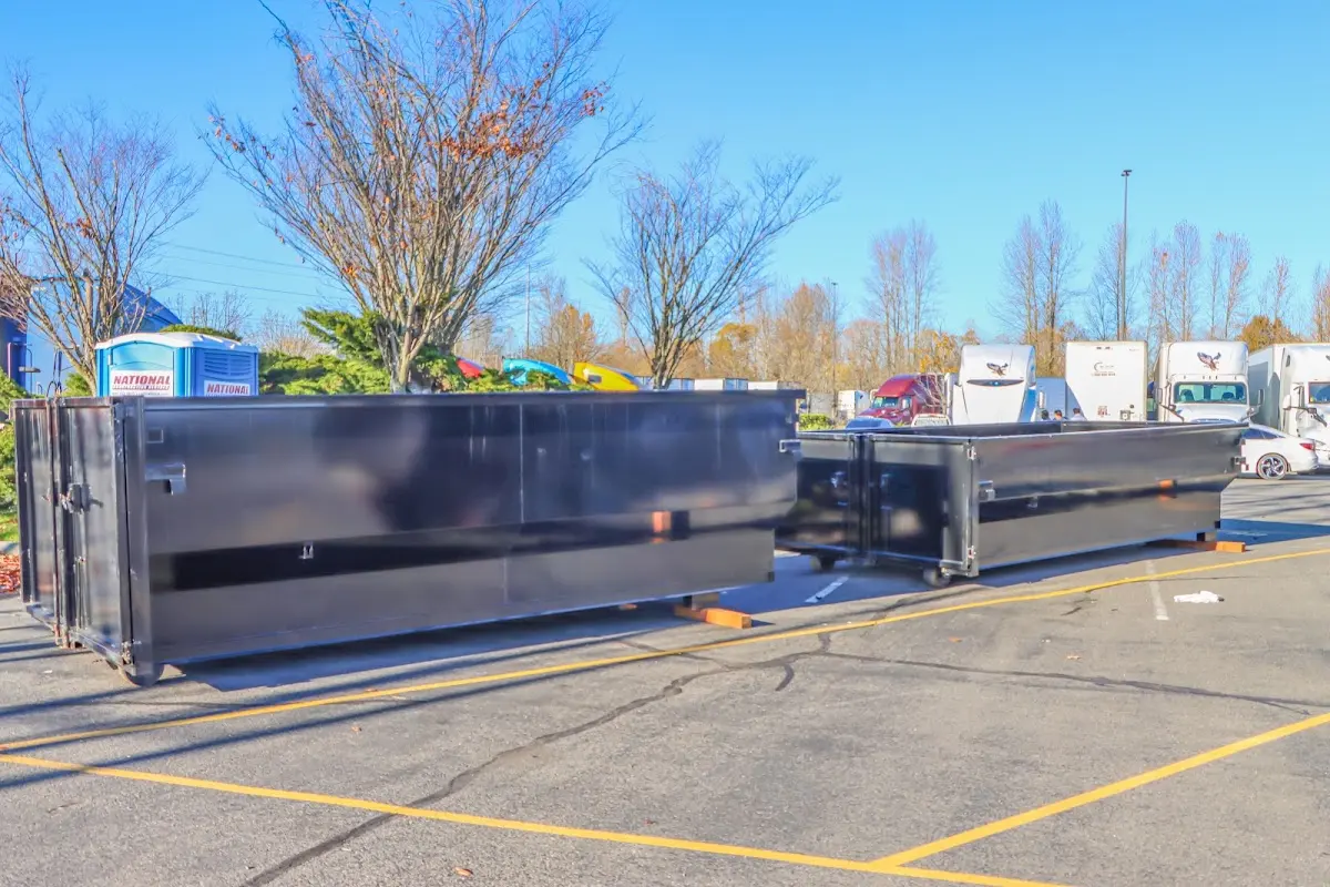 Professional dumpster rental service with roll-off container on residential driveway in Bay Harbor Islands